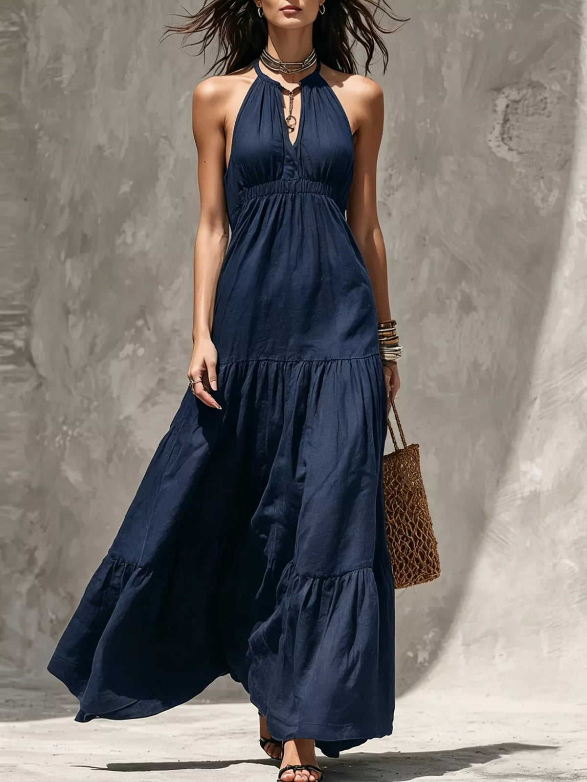 Navy blue halter tiered maxi dress with gathered bodice and layered skirt ruffles.