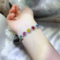 925 sterling silver bracelet with multicolor round gemstone charms on wrist