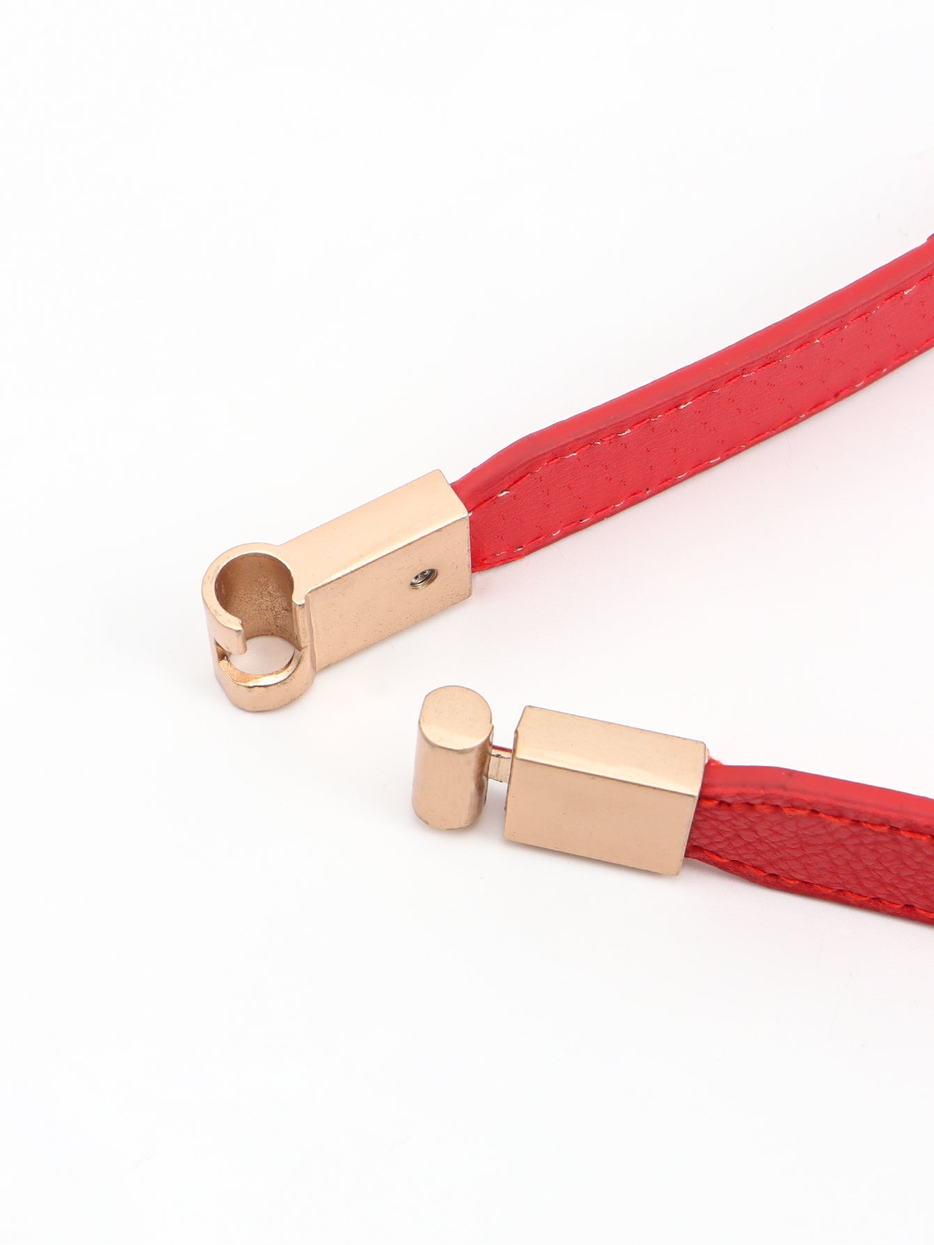Red elastic skinny belt with rose-gold buckle and loop detail
