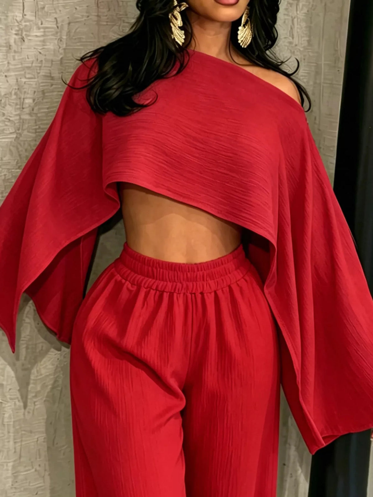 Red boat-neck crop top and wide-leg pants set, draped cape sleeves