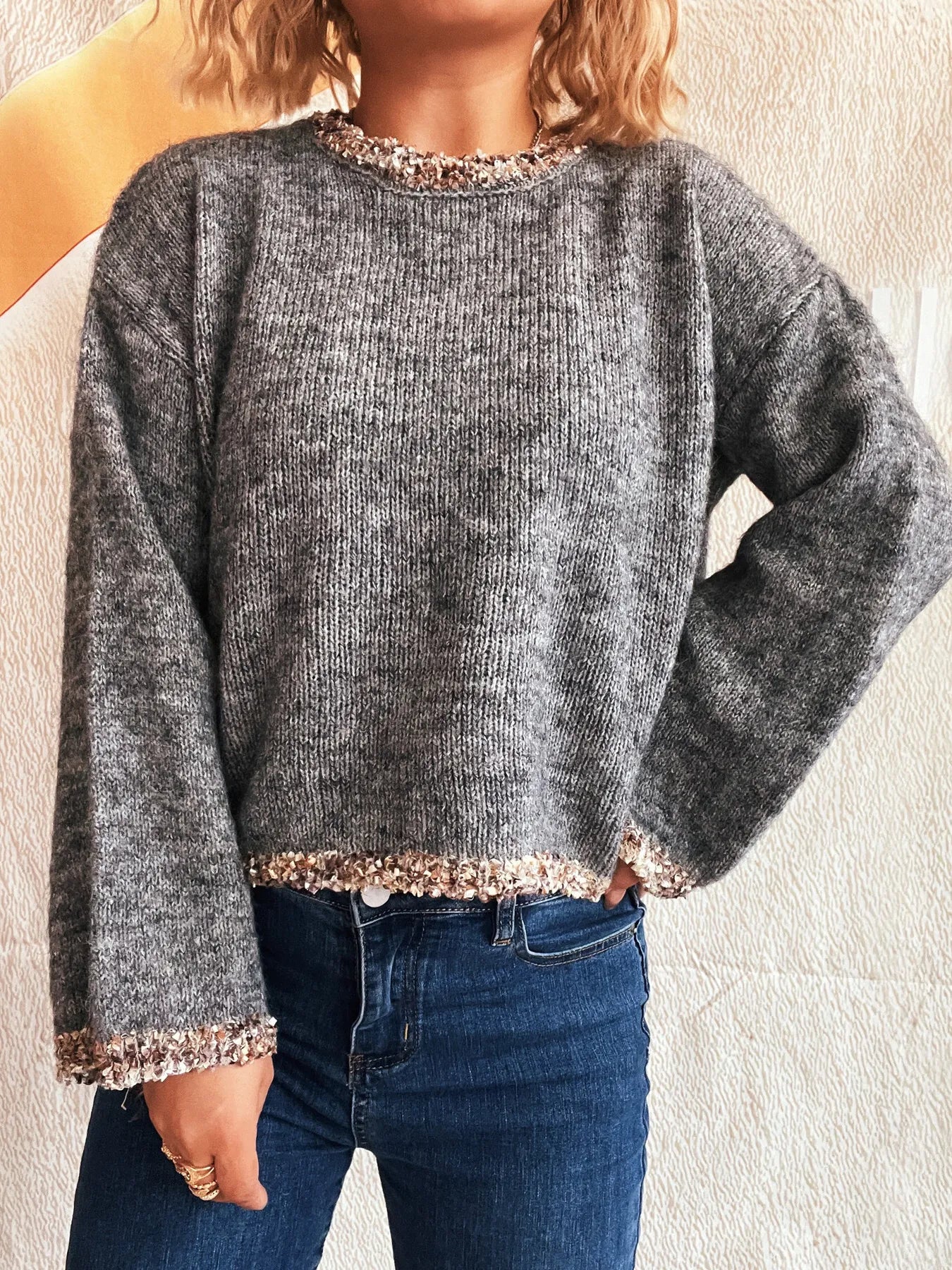 Dark gray cropped round-neck sweater with glittery rose-gold trim at hem and cuffs