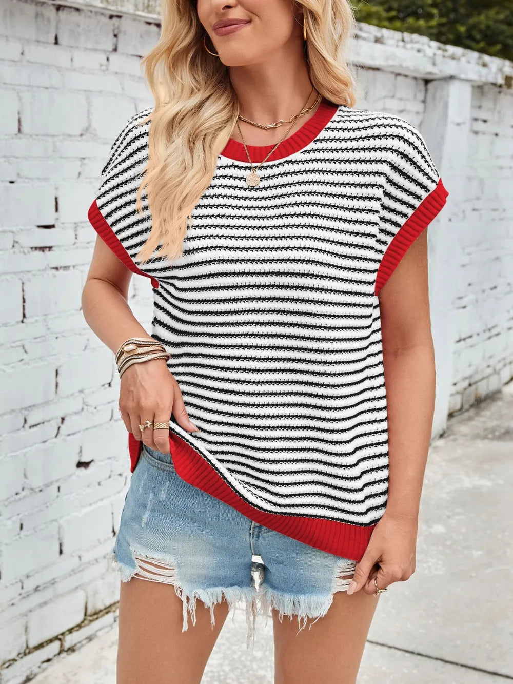 Striped cap-sleeve sweater with round neck, black-and-white stripes and red trim