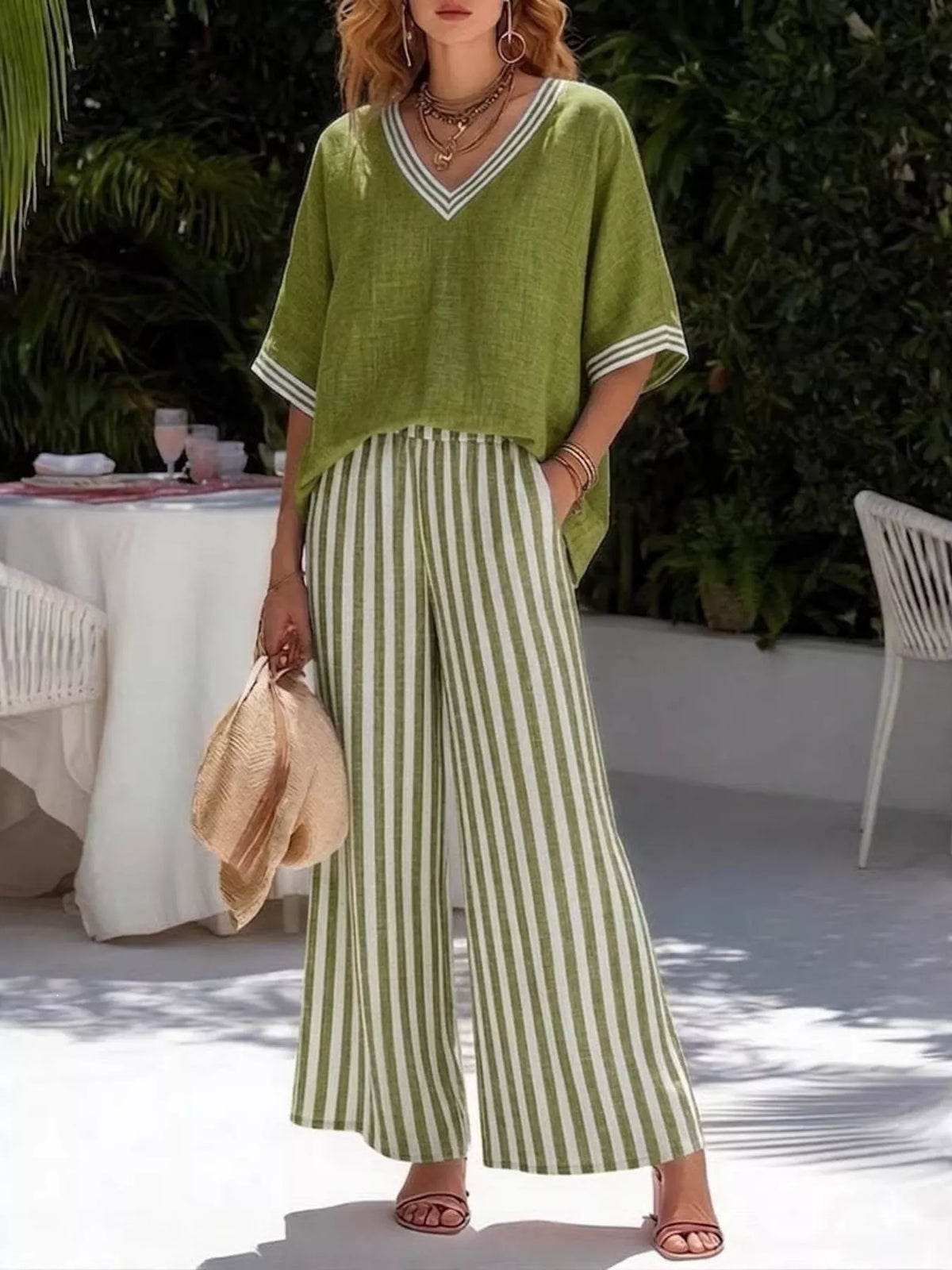 Green V-neck loose top with striped wide-leg pants, two-piece casual set.
