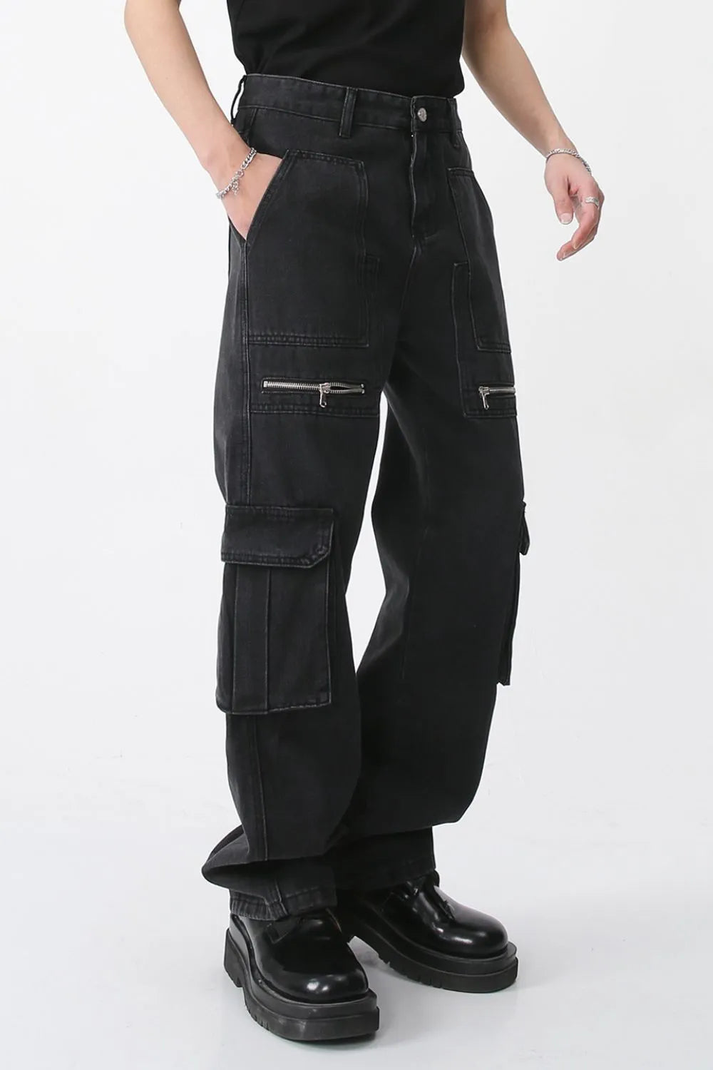 Dark loose-fit jeans with stacked cargo pockets and wide straight legs