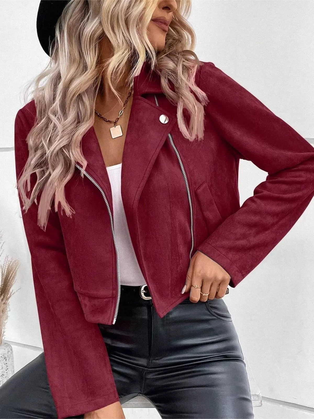 Burgundy women’s zip-up moto jacket with lapels, snap collar, and side pockets