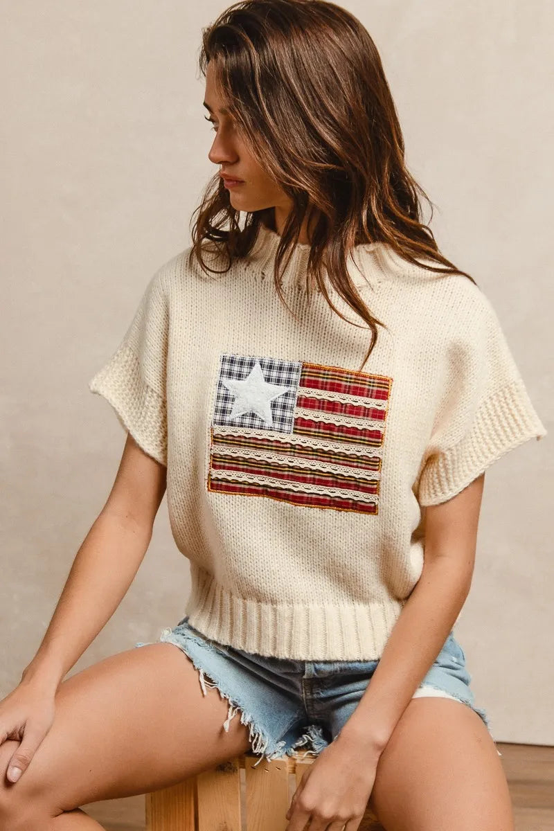 Oatmeal knit sweater with American flag patch, ribbed cuffs and hem, short sleeves