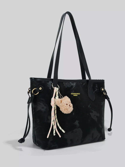 Black bear charm shoulder bag with tassel fringe, two top handles, drawcord sides