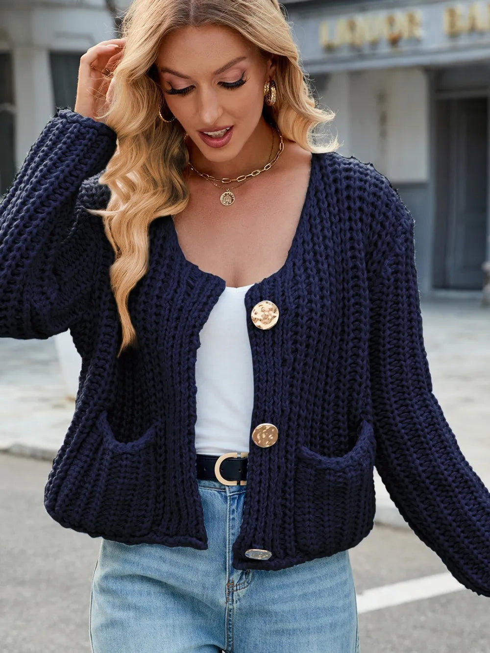 Dark navy round-neck button-up cardigan with button placket and front pockets