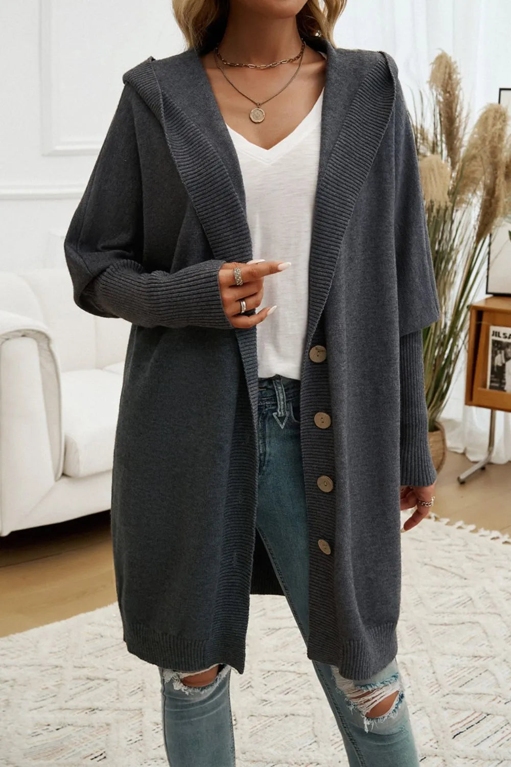 Dark gray hooded long cardigan with button front and ribbed knit texture.
