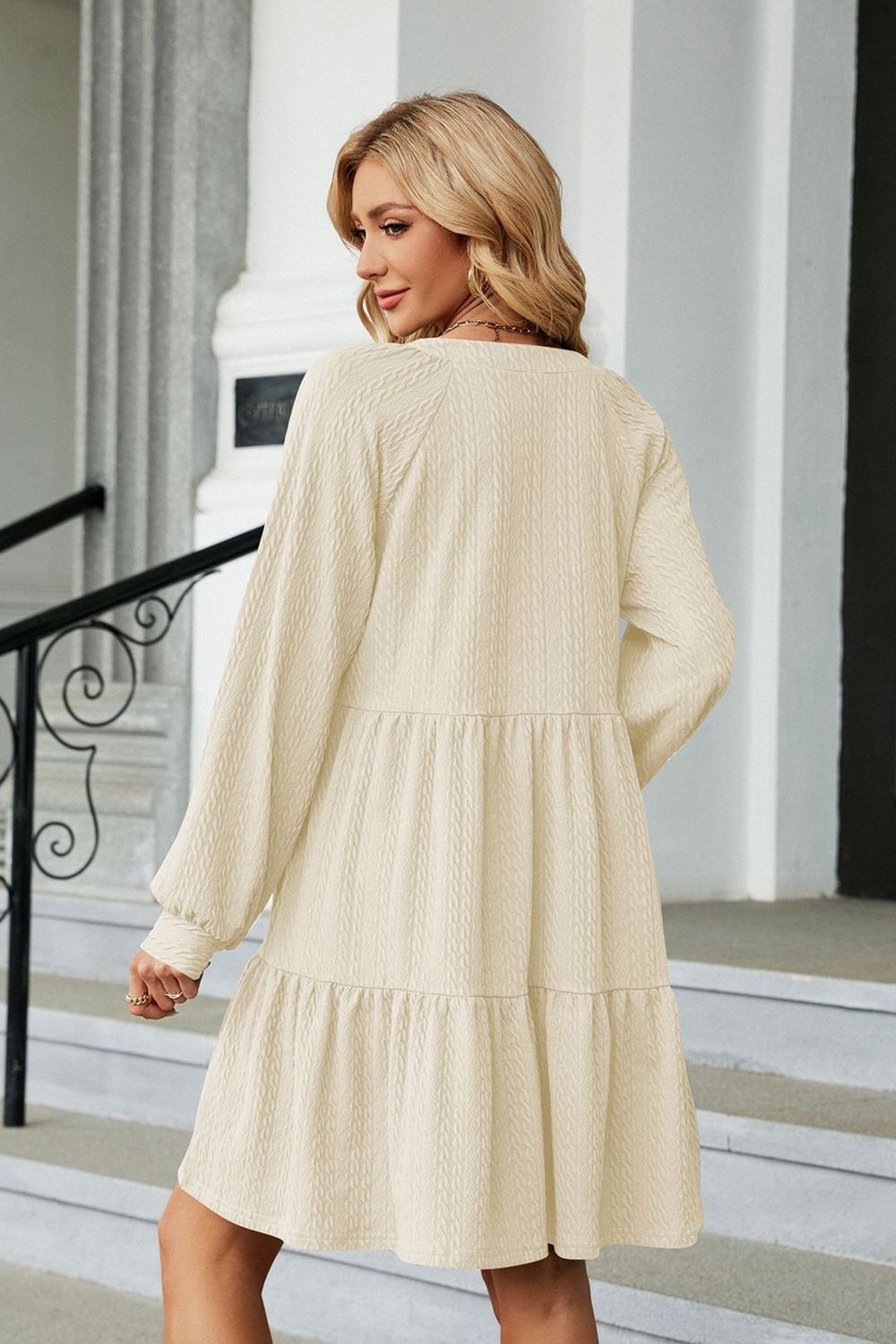 Cream notched-neck long-sleeve mini dress, back view with tiered hem