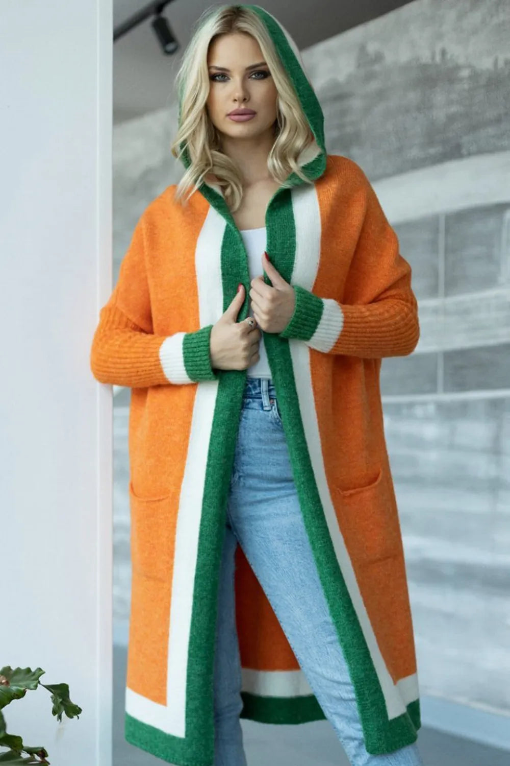 Orange hooded long-sleeve cardigan with green and white striped contrast panels
