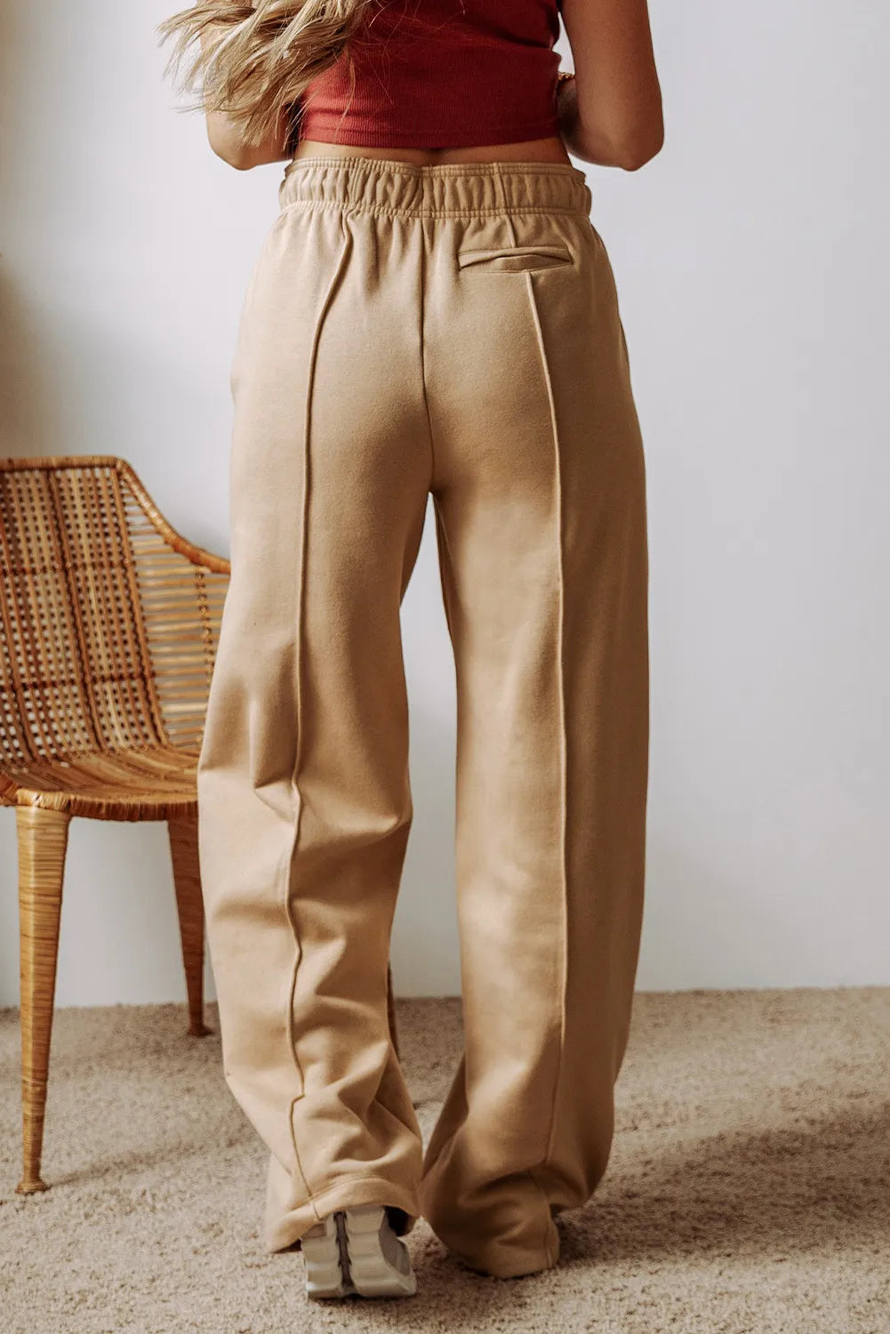 Tan wide-leg drawstring pants with front pleats and side pockets