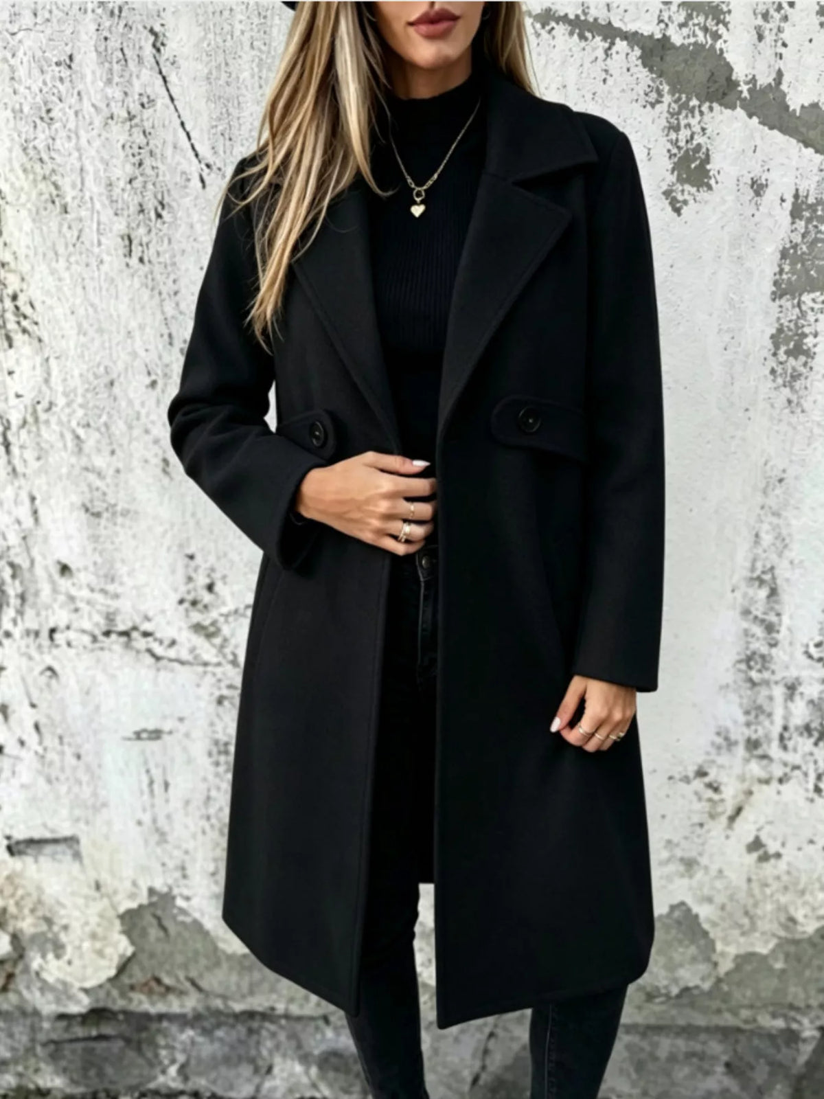 Black longline button-lapel coat with flap pockets and front buttons