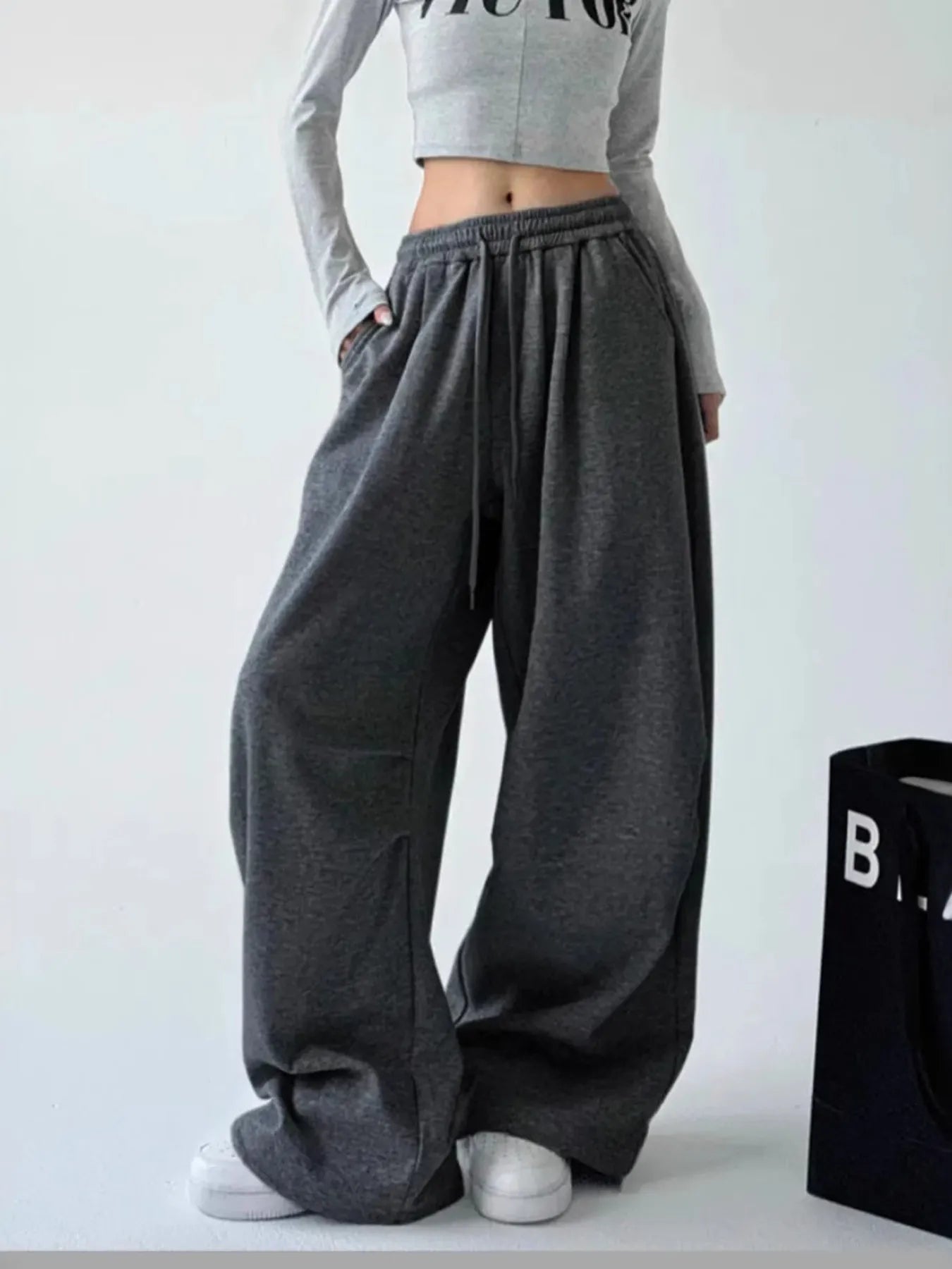 Dark gray oversized wide-leg drawstring pants with gathered elastic waistband