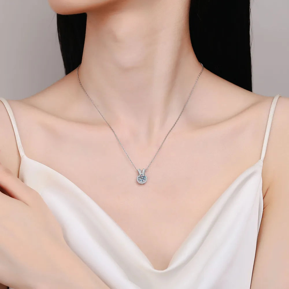 Silver rabbit-ear pendant necklace worn on neck with round moissanite center