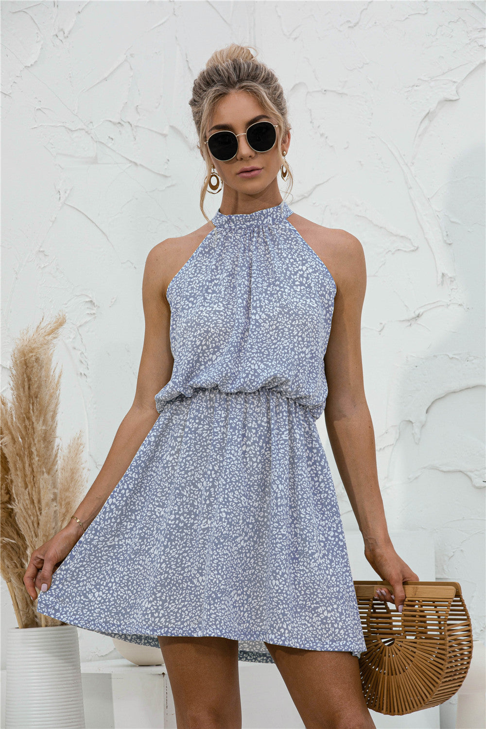 Floral tied sleeveless mini dress in light blue with cinched waist and tiered skirt