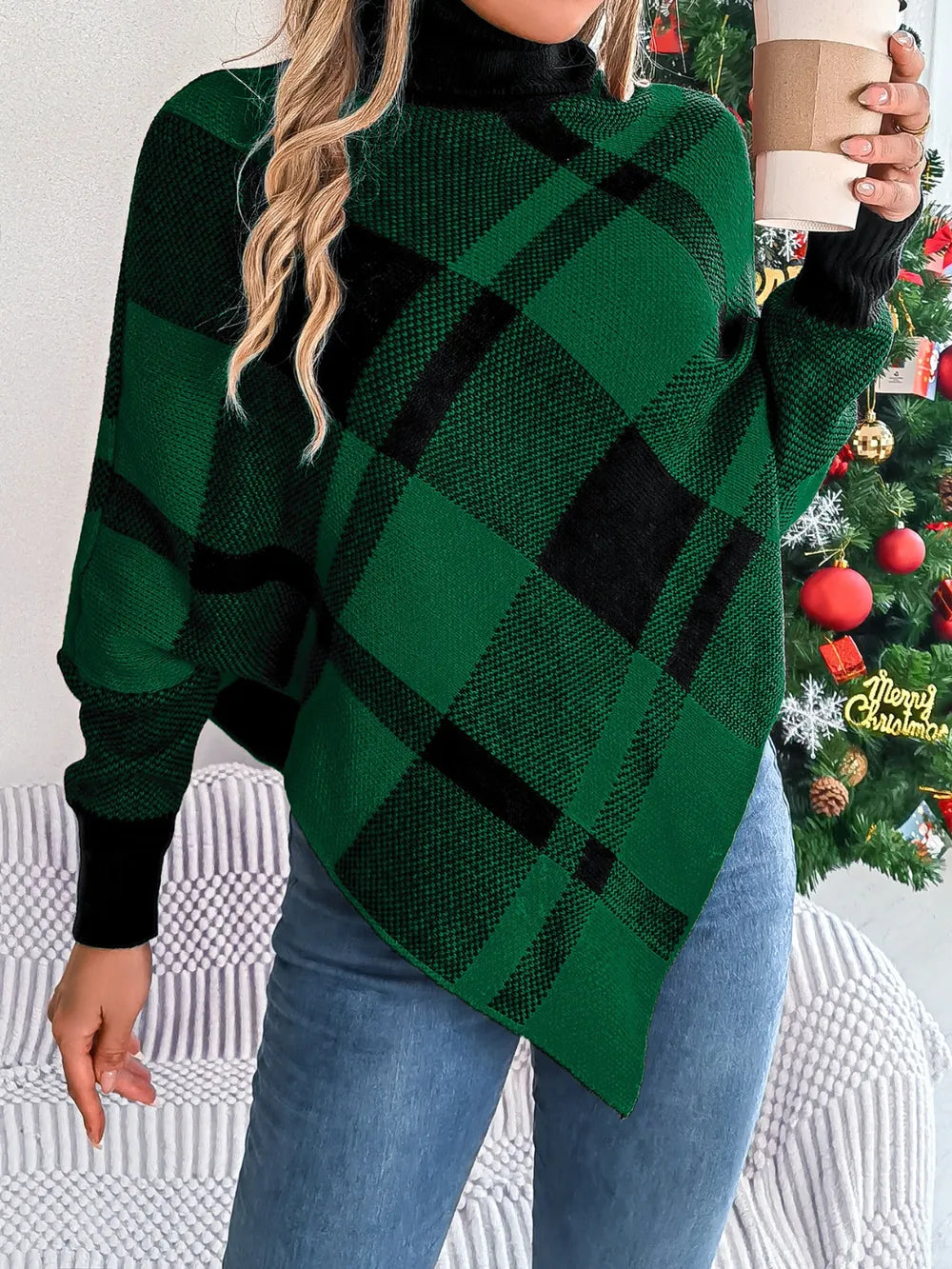 Plaid turtleneck batwing sweater in dark green with black plaid, relaxed drape and high collar.
