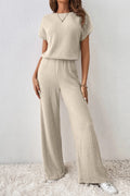 Beige ribbed knit wide-leg jumpsuit with short sleeves and elastic waist