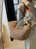 Caramel woven tote with brown leather handle accents and open top design