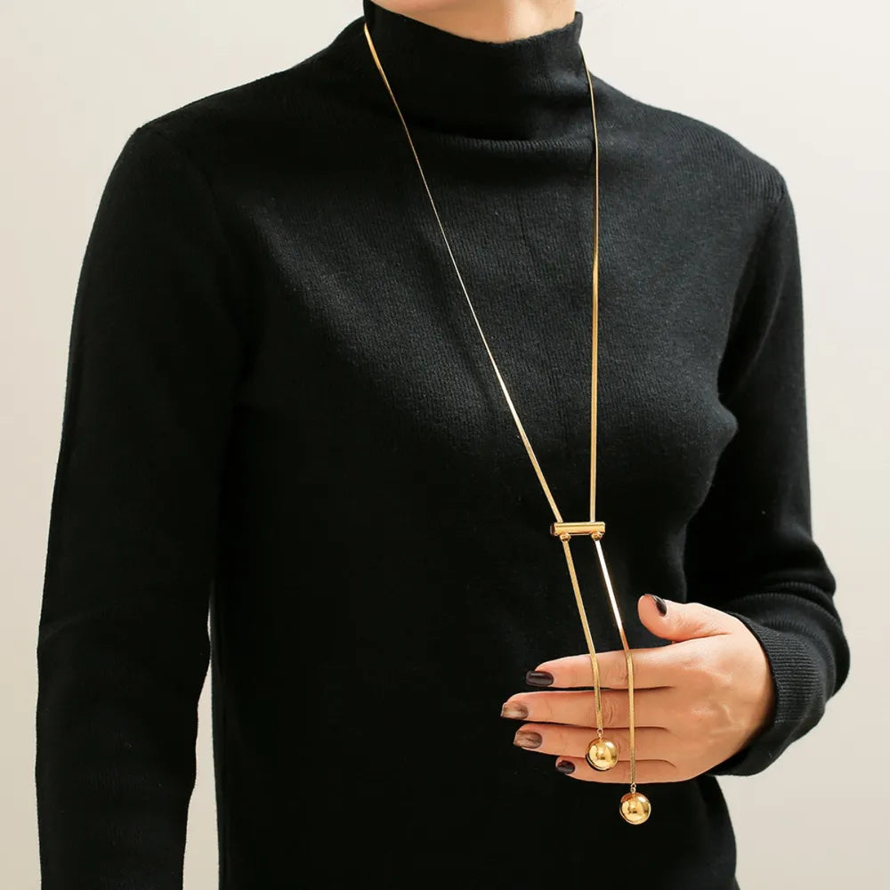 Gold-plated bead necklace with long double strands and round hollow pendants