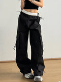 Black cargo pants with elastic waist and large cargo pockets with tie straps