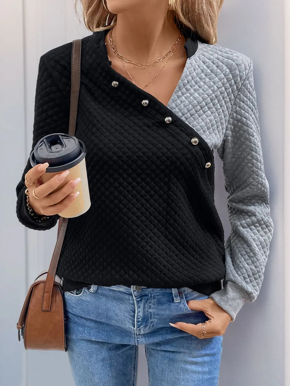 Contrast long-sleeve sweatshirt with decorative buttons, black front and gray sleeves