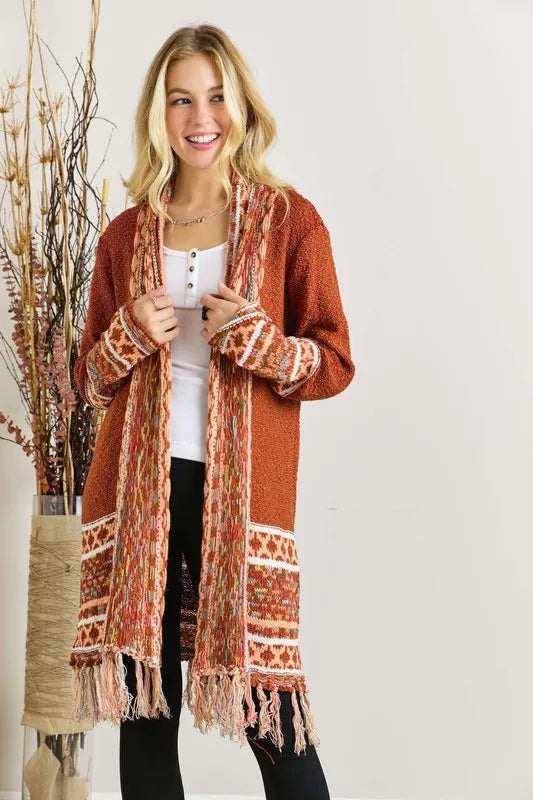 Rust aztec border cardigan with fringe hem and patterned cuffs, open front