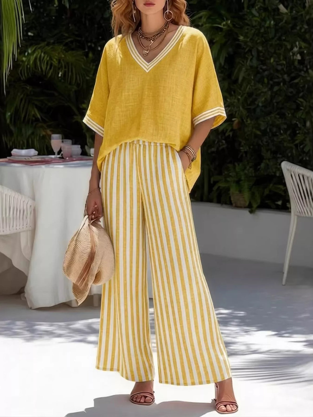 Yellow V-neck loose top with striped wide-leg pants, two-piece casual set.
