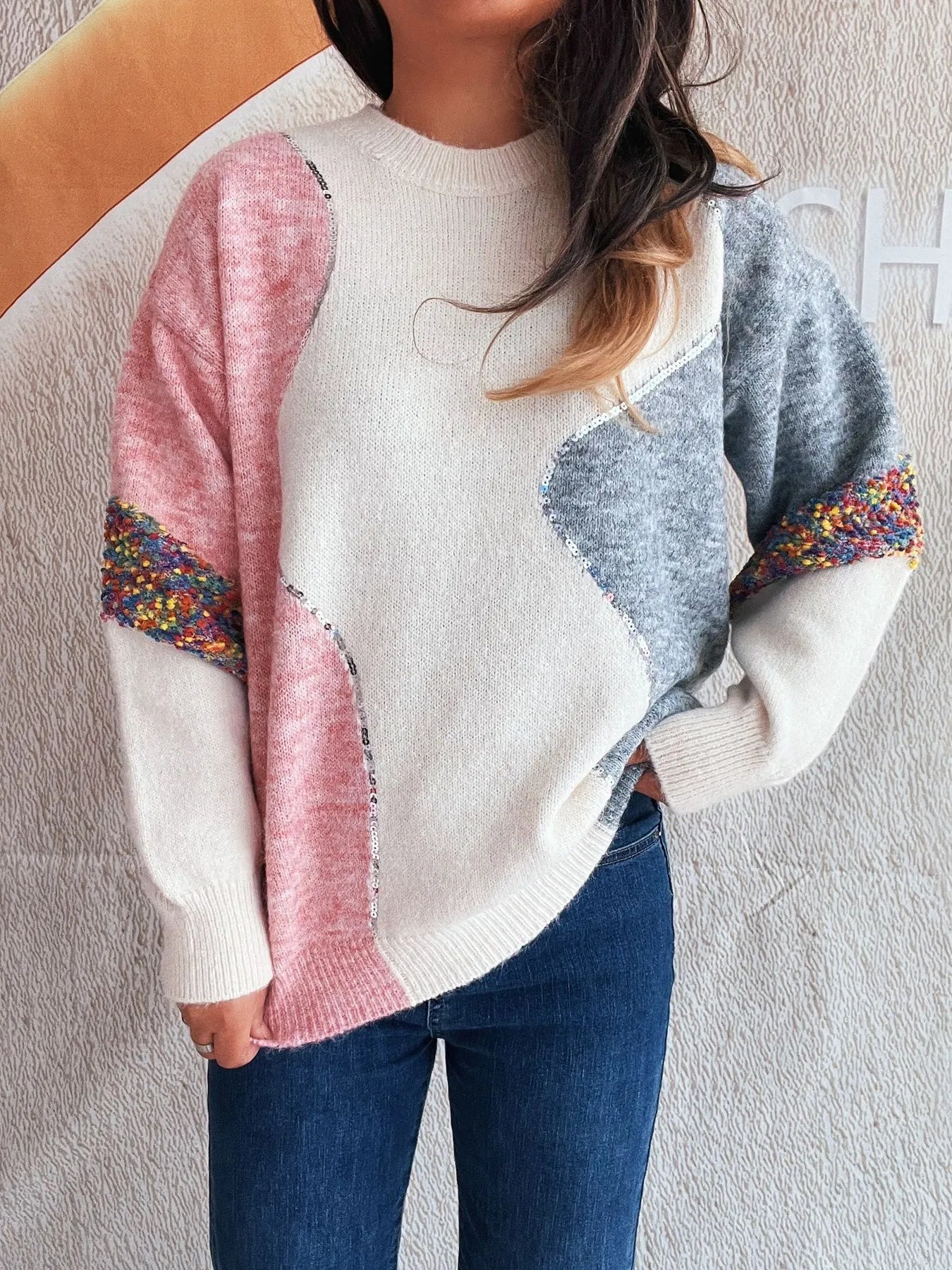 Dropped shoulder sweater in white with pink left sleeve and blue right panel, crew neck