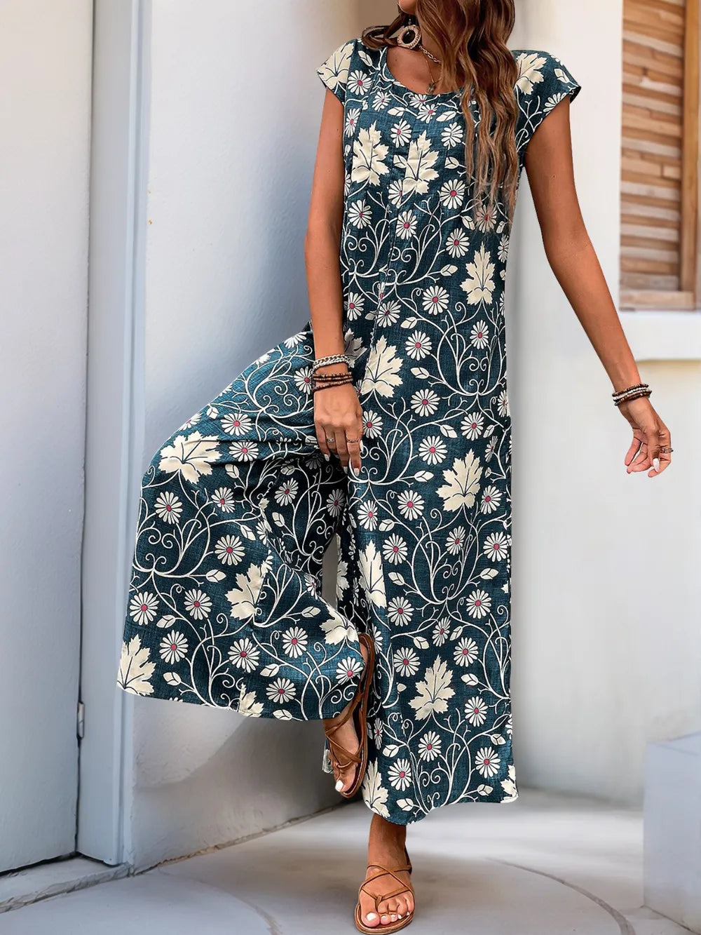 Dark teal printed wide-leg jumpsuit with round neckline and cap sleeves