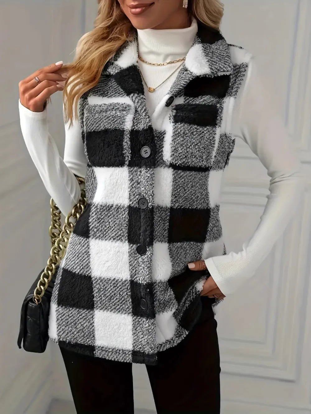 Sleeveless sherpa vest coat in black-and-white plaid with button front and lapels