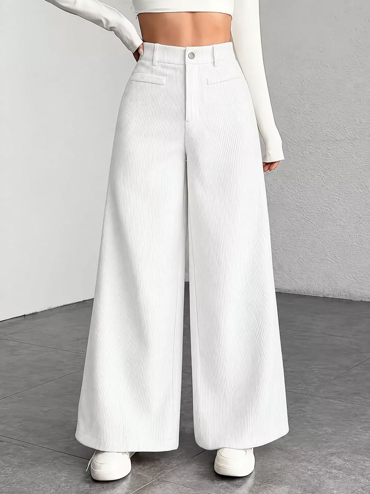 High-waisted wide-leg pants in white with front pockets and button closure.