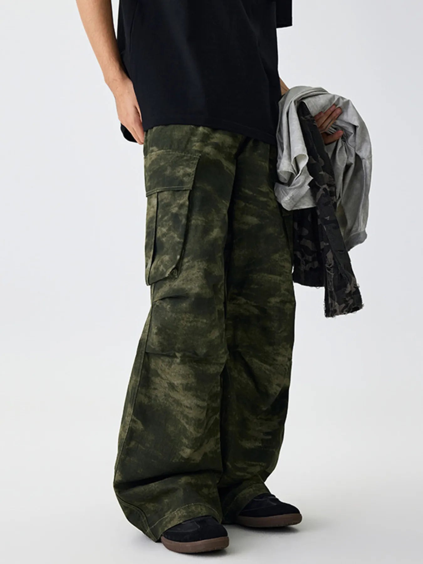 Green camouflage cargo pants with flap cargo pockets and relaxed fit