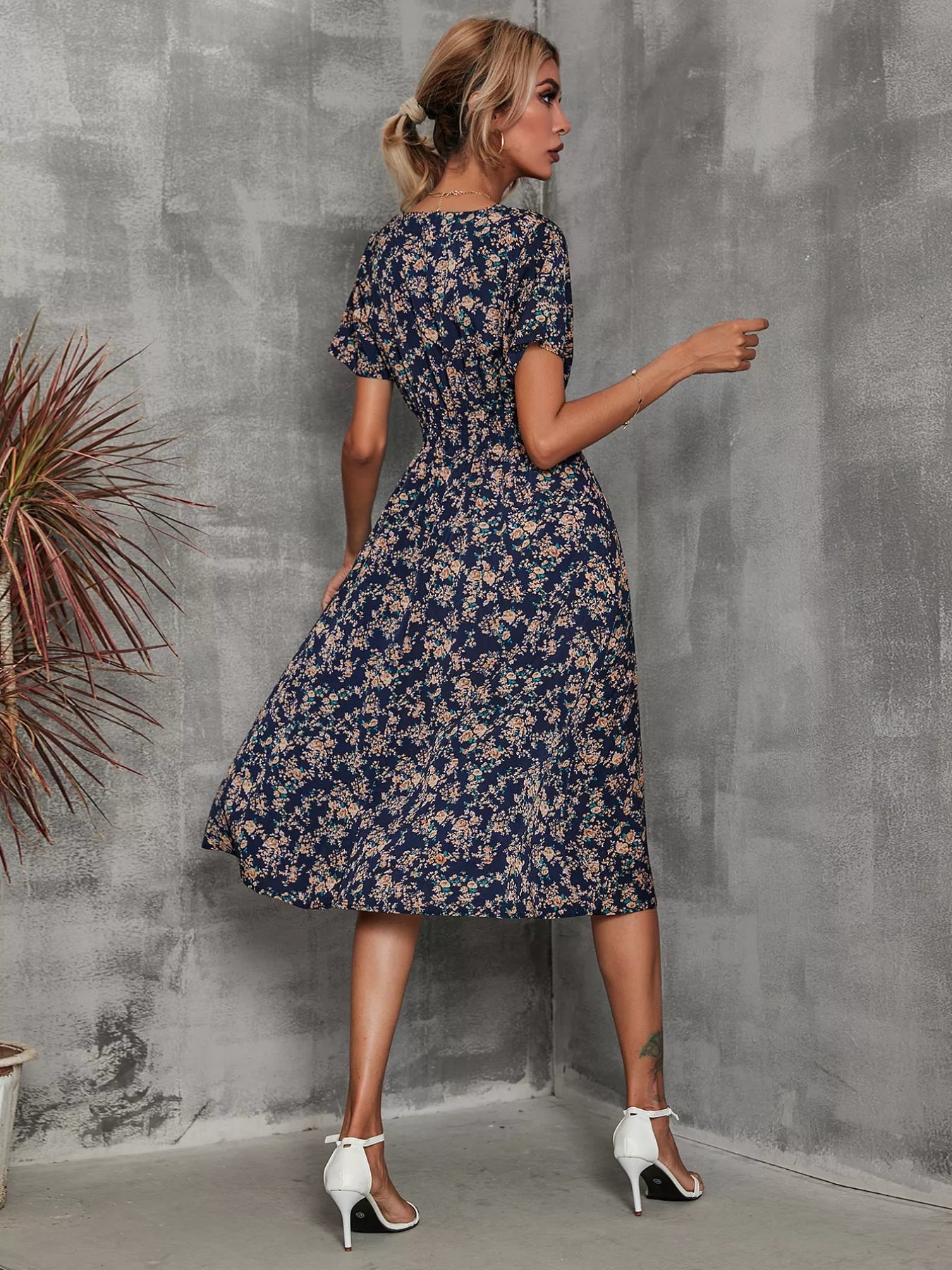 Printed short sleeve midi dress in navy with small blue floral print, flared skirt.