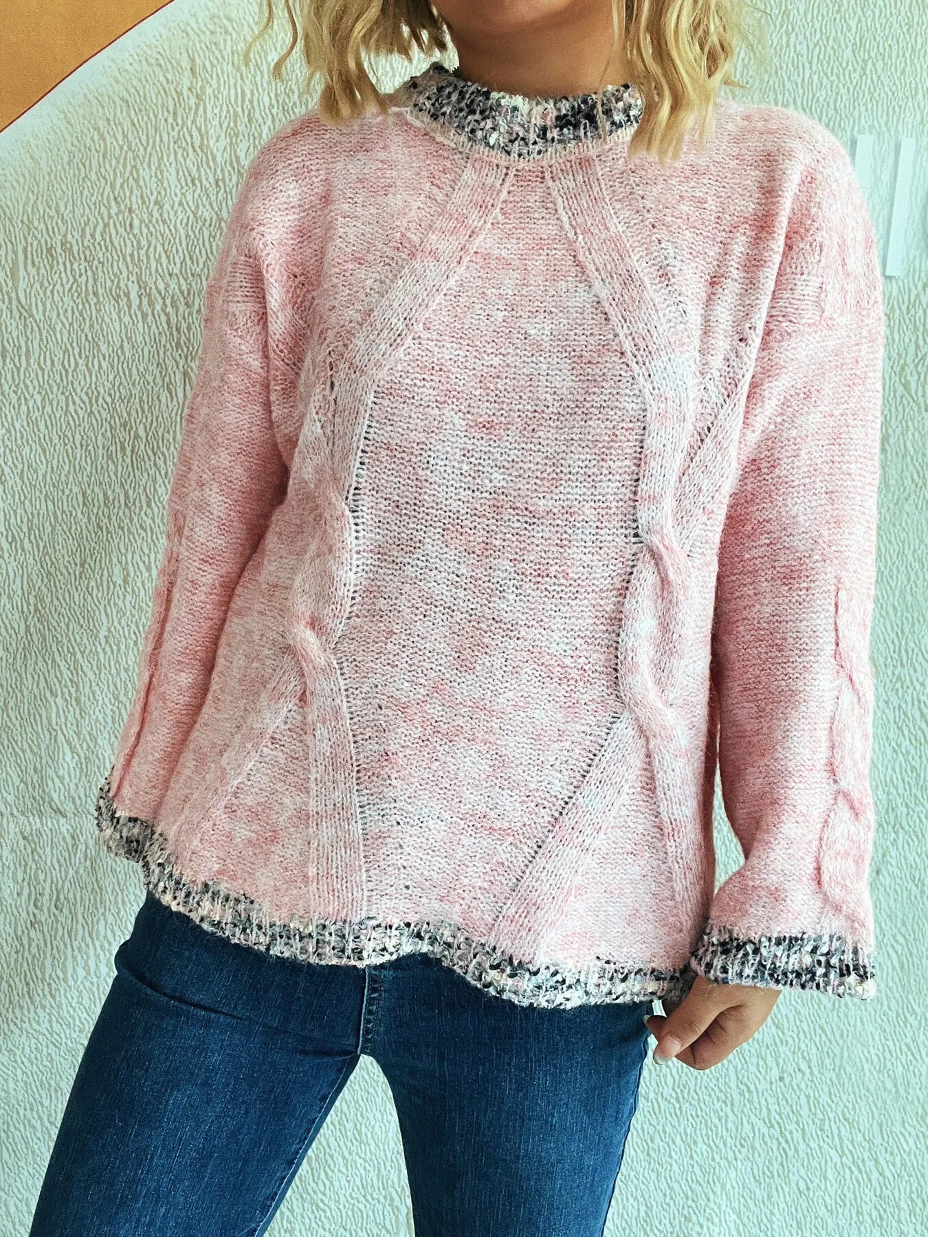 Pink contrast-trim round-neck sweater with textured pattern and scalloped-look hem detail.