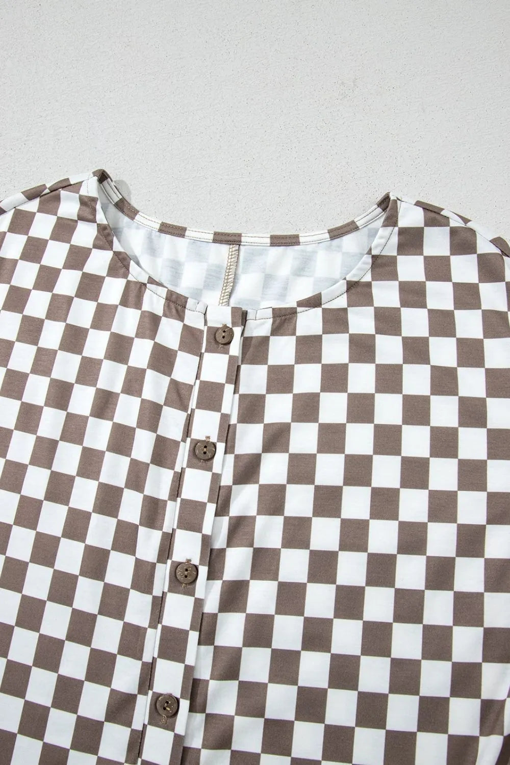 Brown-and-white checkered sleeveless crew neck jumpsuit bodice with button placket