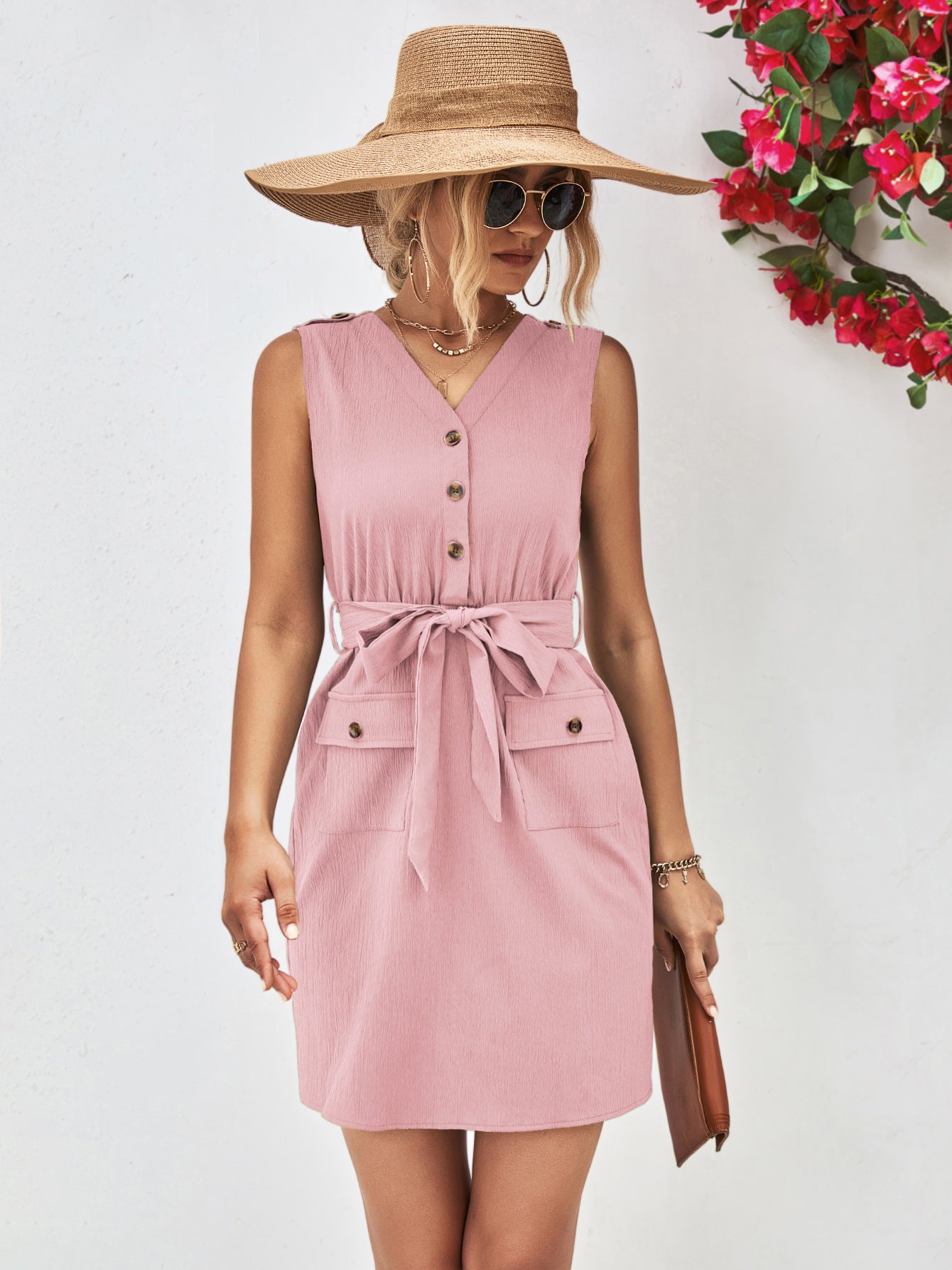 Blush pink sleeveless V-neck button dress with tied waist belt and pocket detailing