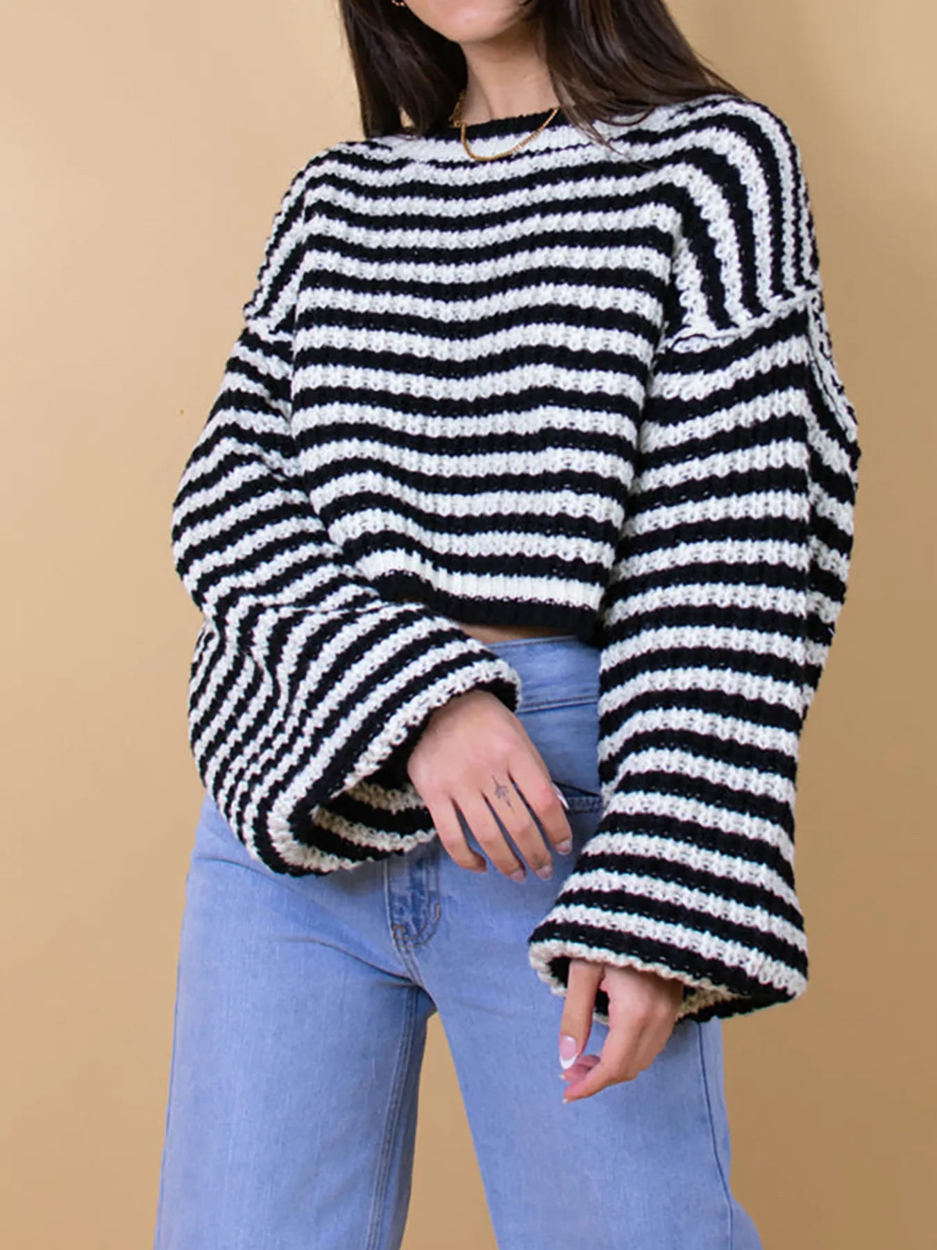 Black-and-white striped oversized drop-shoulder sweater with thick ribbed neckline