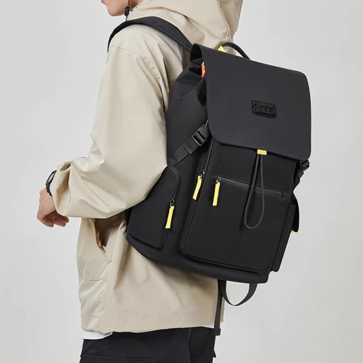 Cedar & Moore Flap-Over Backpack in black, large Trendsi bag with yellow zipper pulls.