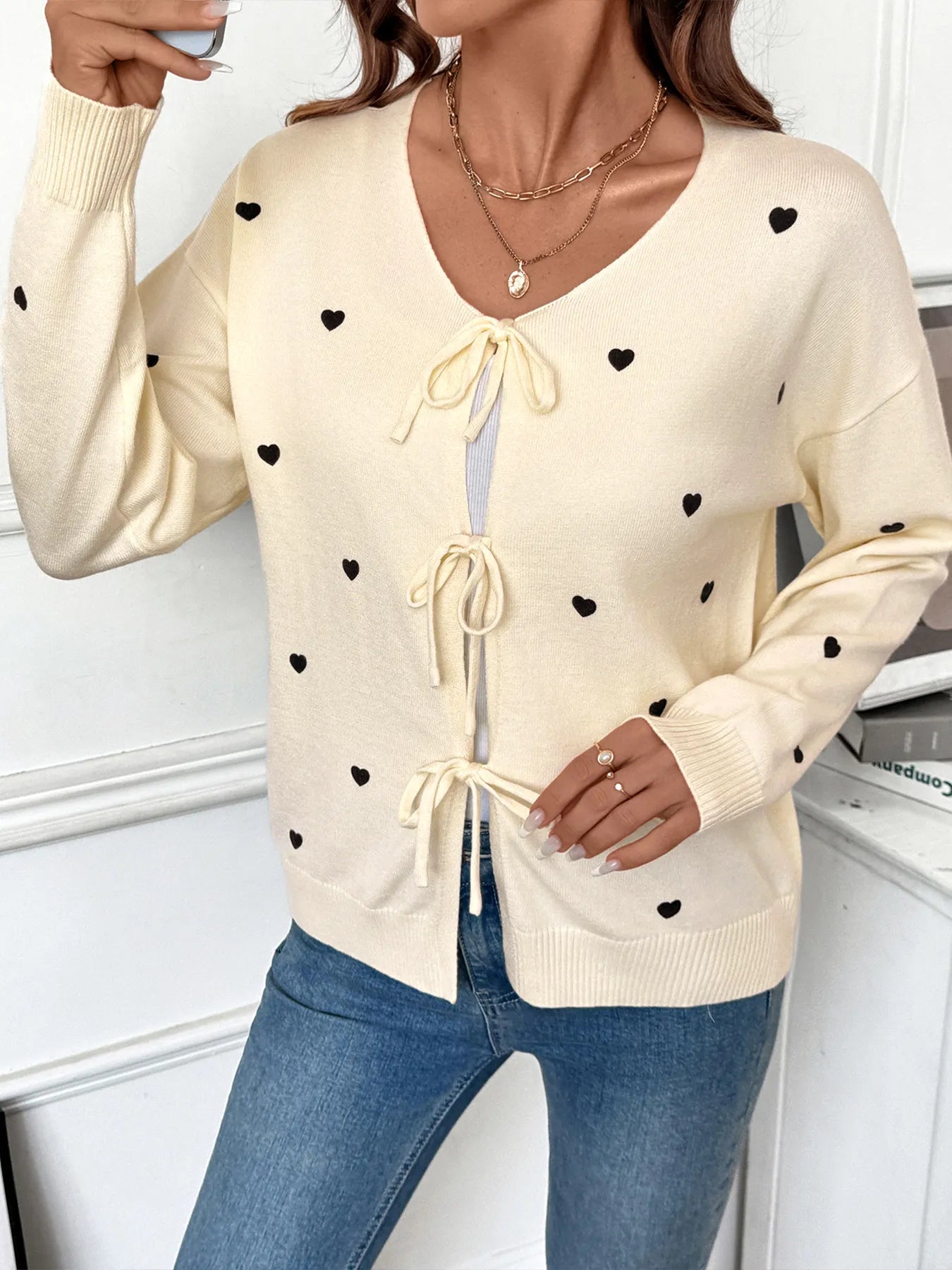 Cream heart tie-front long sleeve cardigan with V-neck and bow tie front details