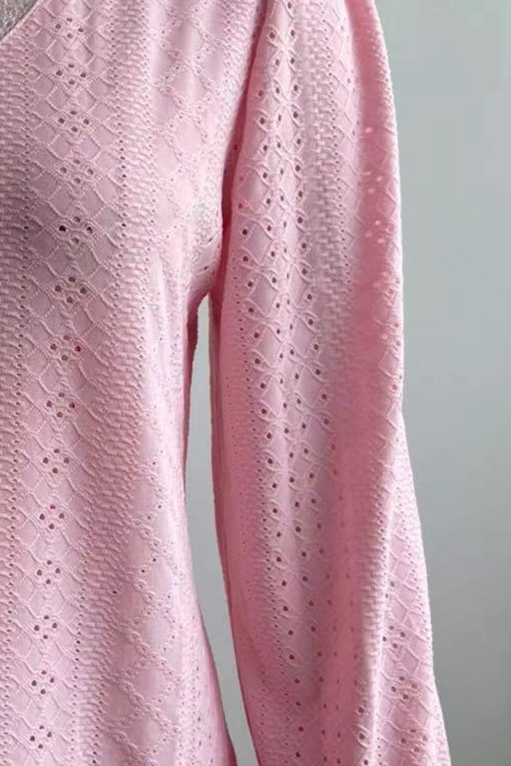 Pink eyelet V-neck blouse with flounce sleeve, textured lace pattern