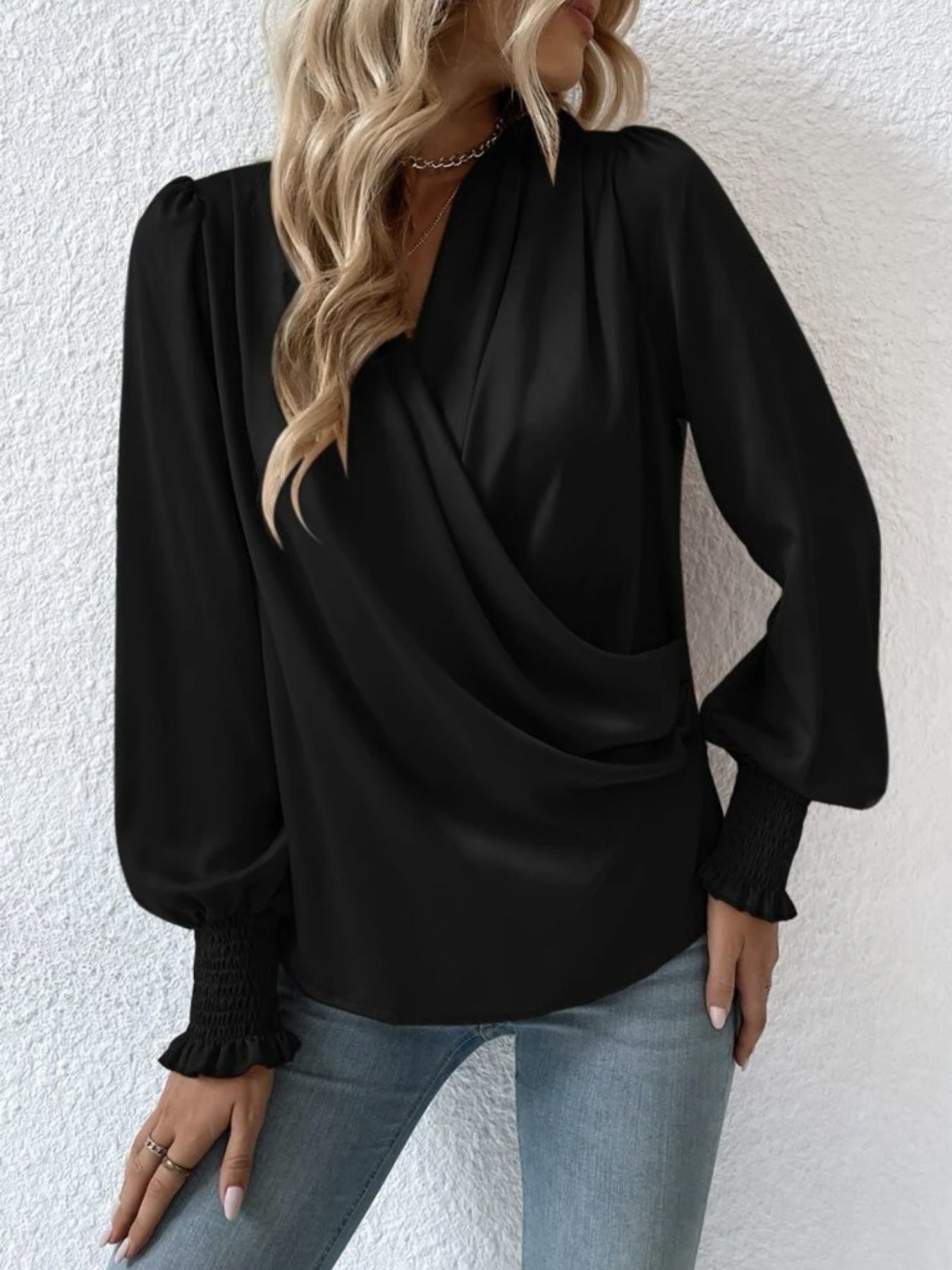 Ruched surplice long-sleeve blouse in black by Trendsi with wrap-front.