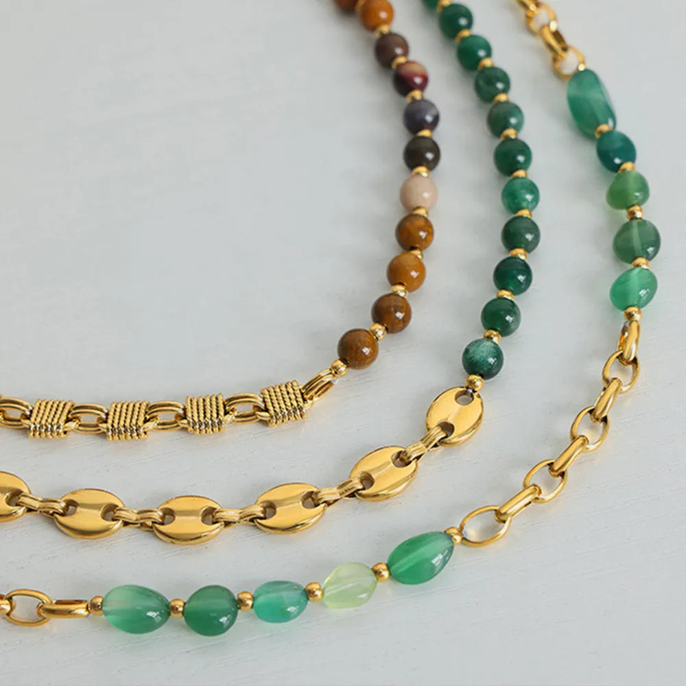 Beaded necklace set with gold chain, green oval beads, and brown and black bead strand