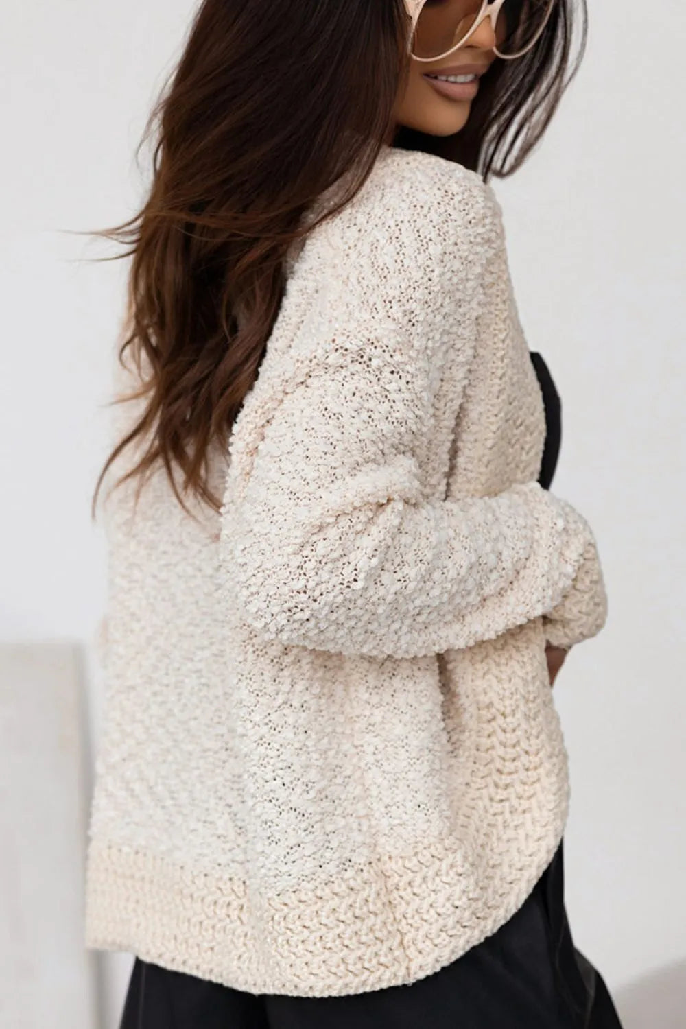 Cream open-front cardigan with long sleeves and textured knit pattern