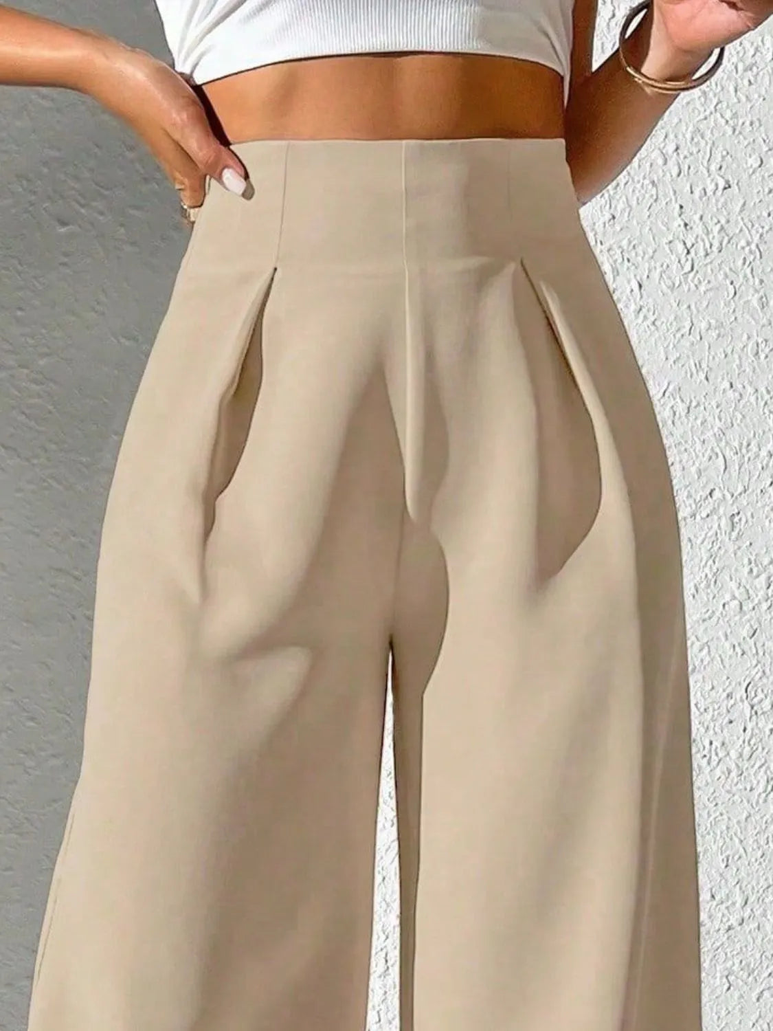 Tan high-waist wide-leg pants with pleated, structured front panel