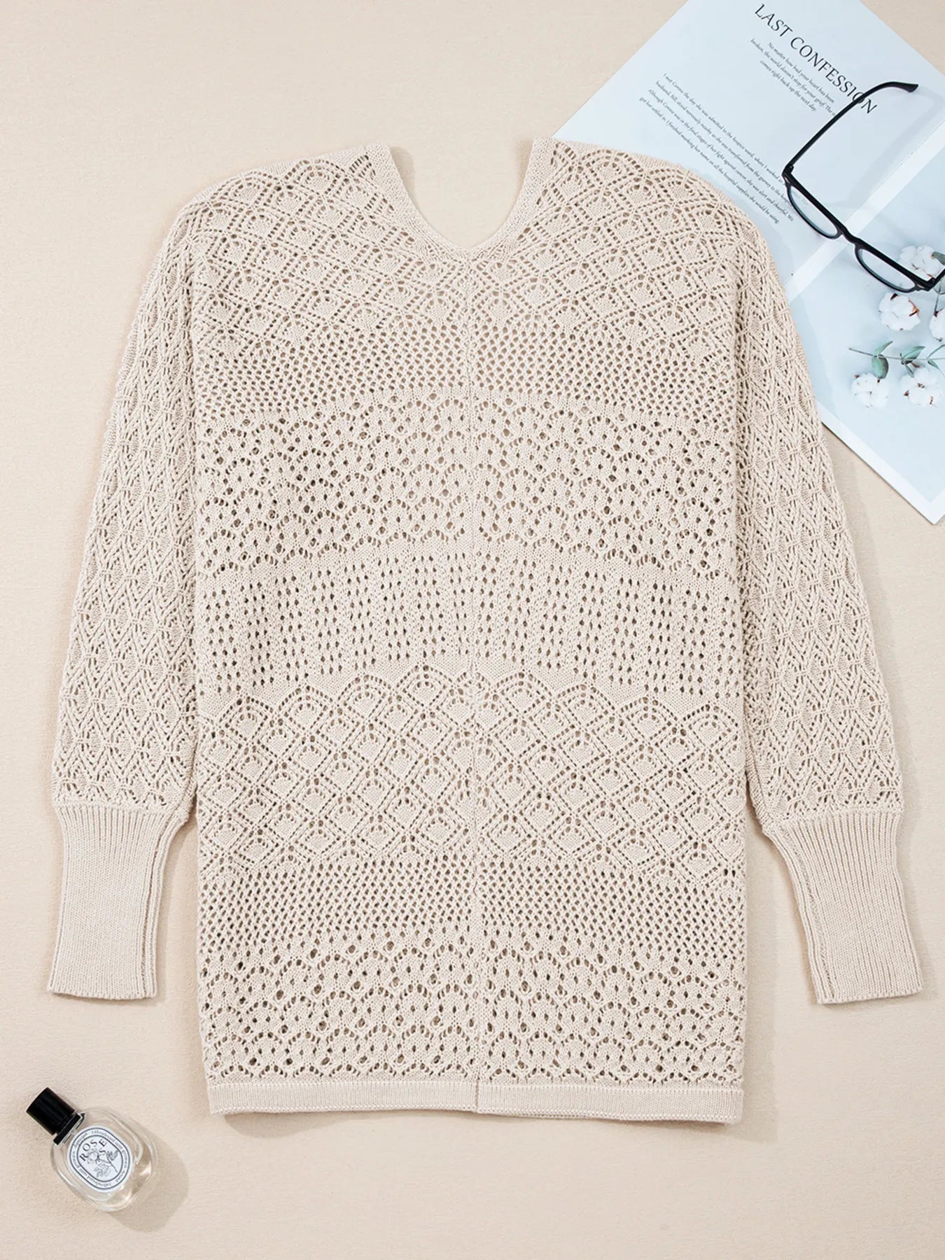 Beige hollow-knit cardigan with V-neck opening and diamond-style openwork stitch