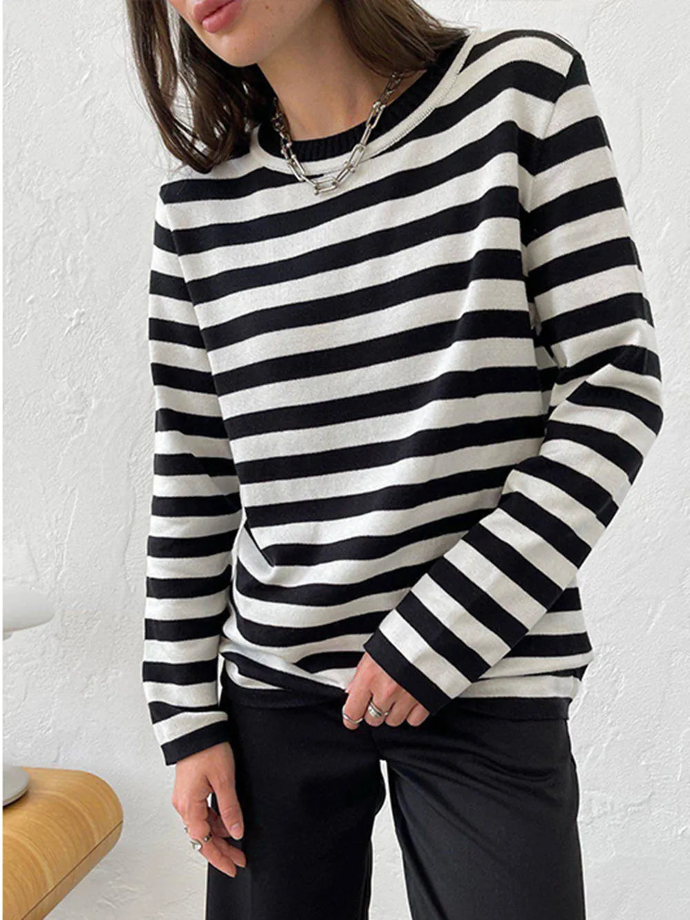 Striped long-sleeve sweater with round neck, black and white horizontal stripes.