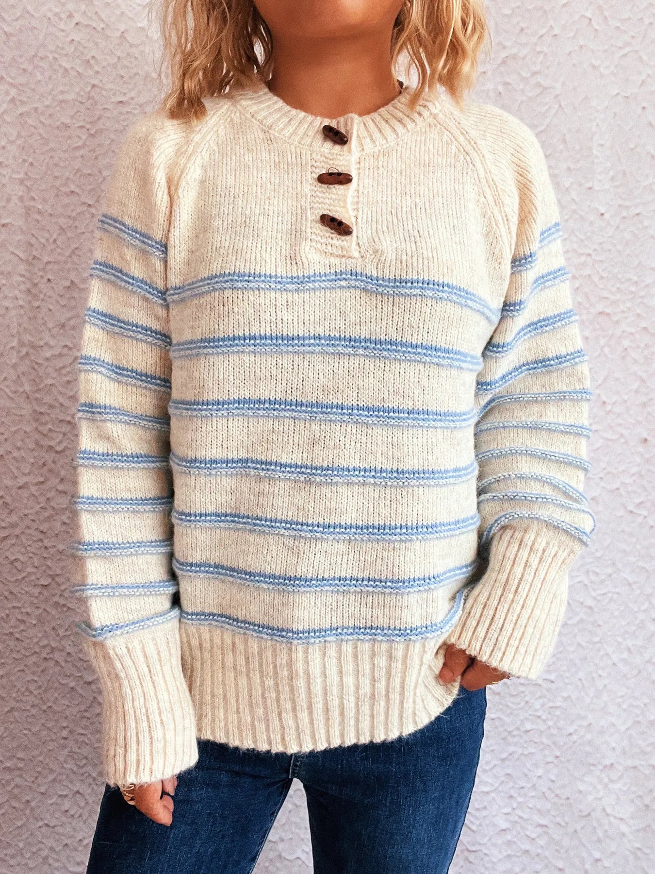Cream striped knit sweater with button-front placket and ribbed sleeve cuffs