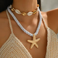 Gold starfish rope necklace with white shell beads, layered choker style