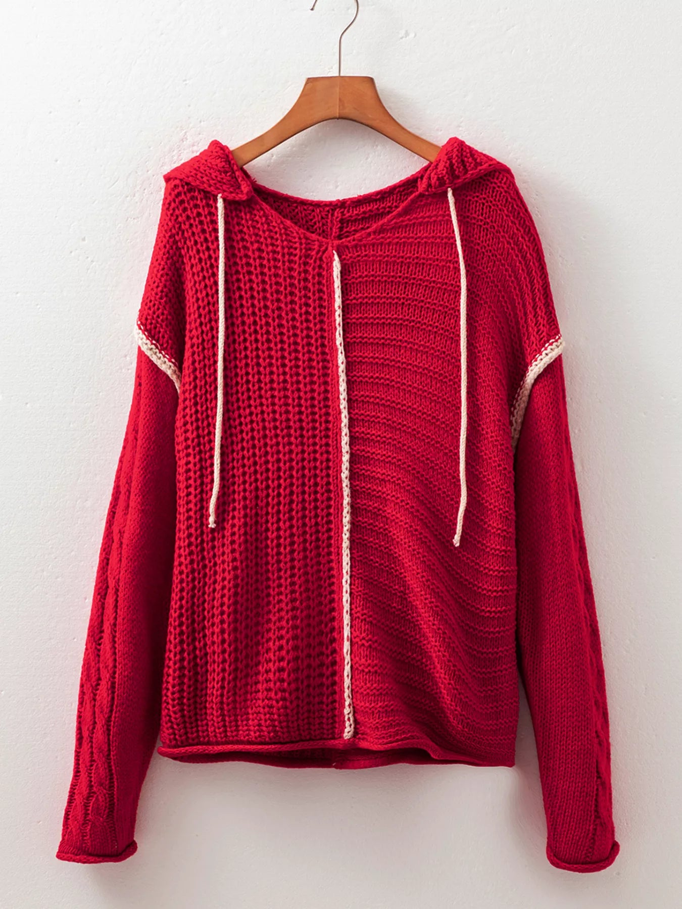 Deep red hooded textured knit sweater on hanger with contrast white trim and strings